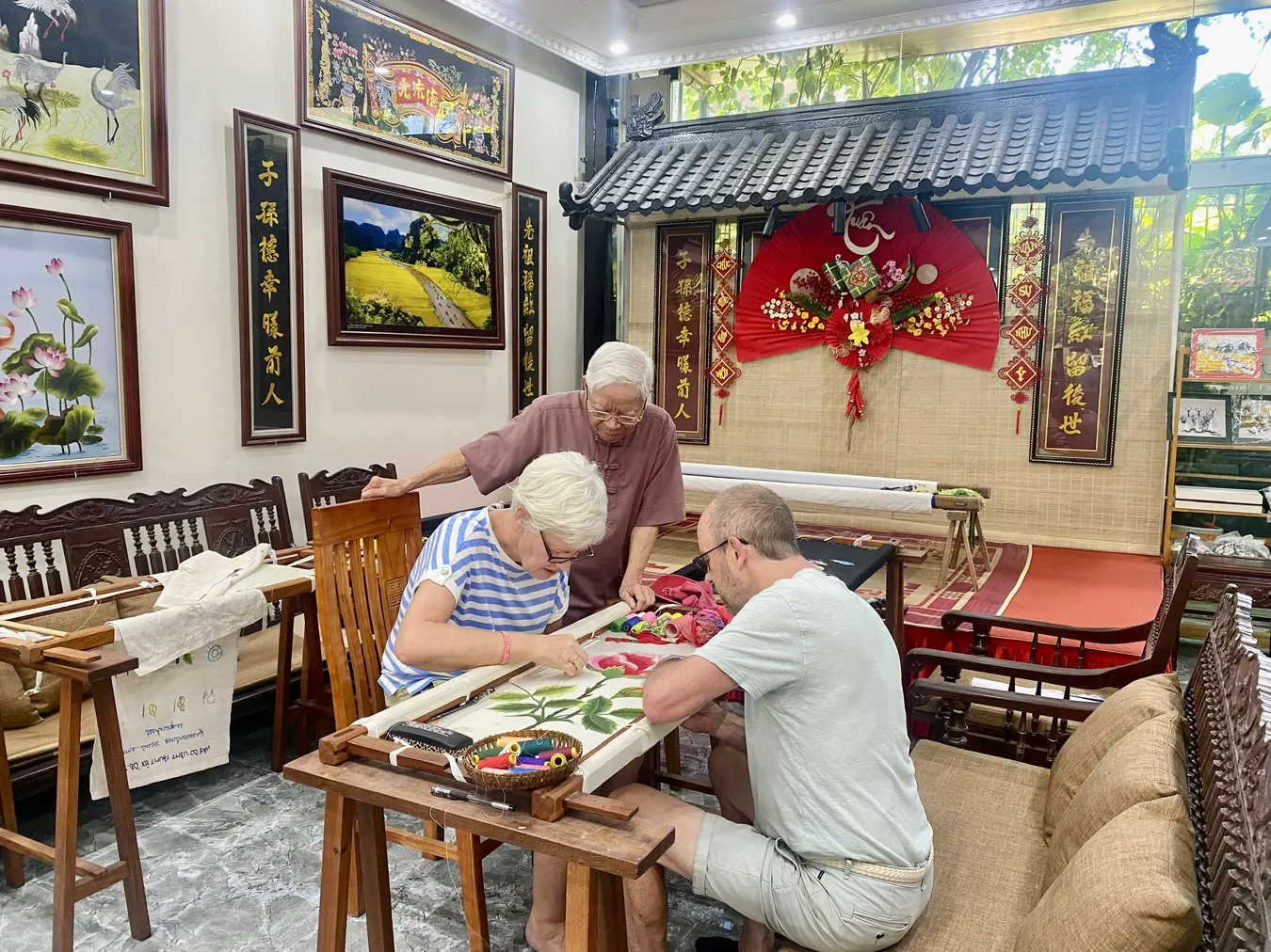 Visitors sharing a traditional hand embroidery activity at Vị & Thêu
