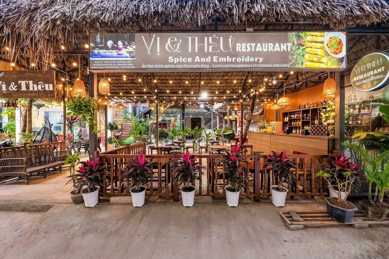 Warmly lit Vị & Thêu restaurant frontage in Tam Coc