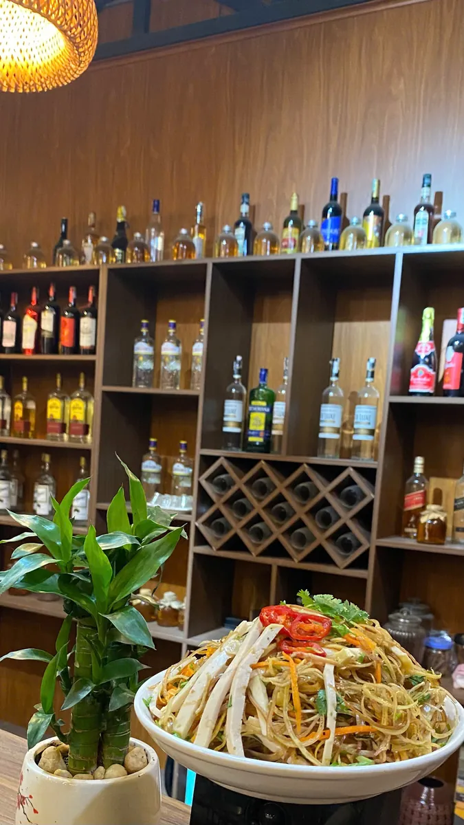 A Vietnamese dish photographed beside the bar and seating at Vị & Thêu