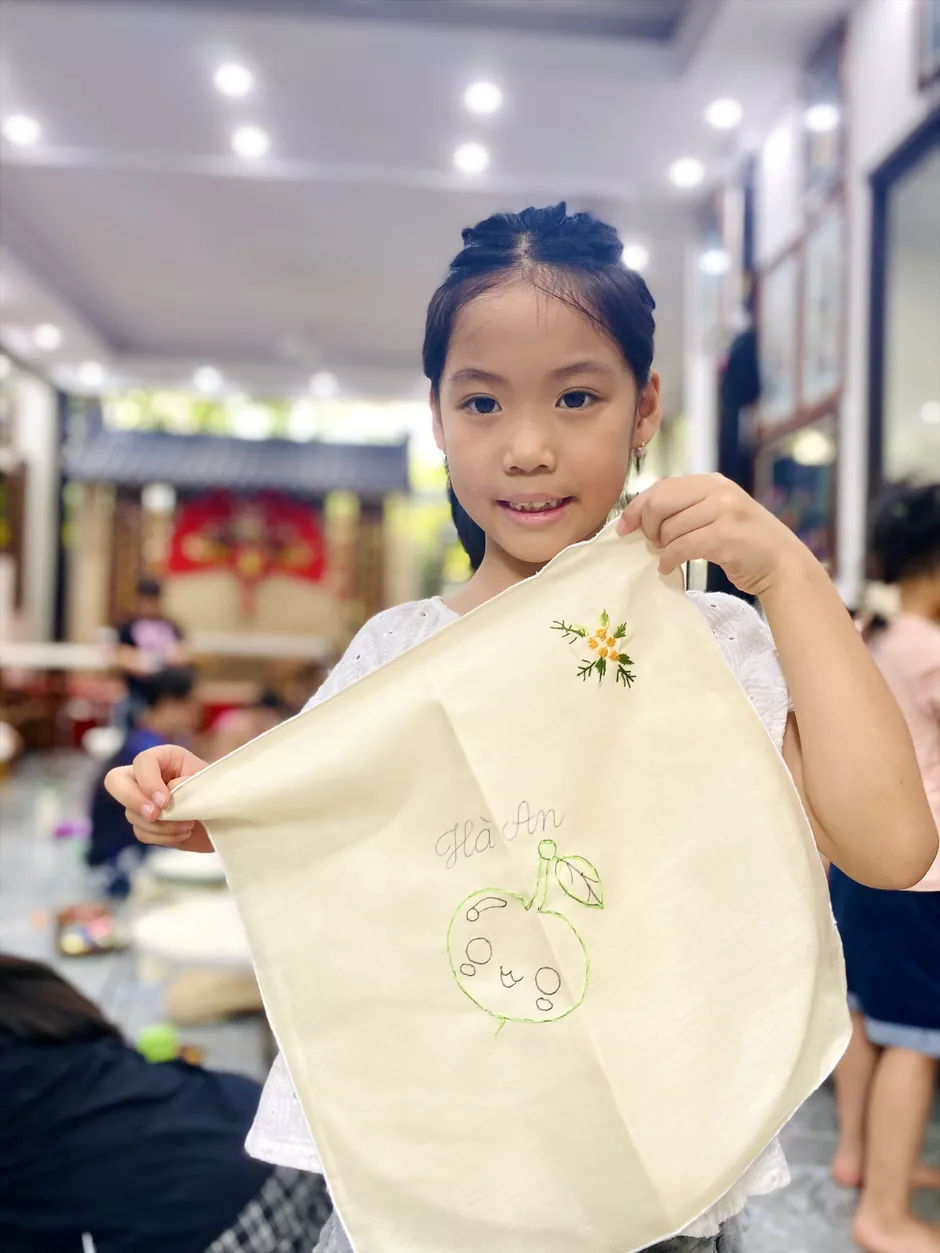 Visitor showing a traditional embroidered cloth